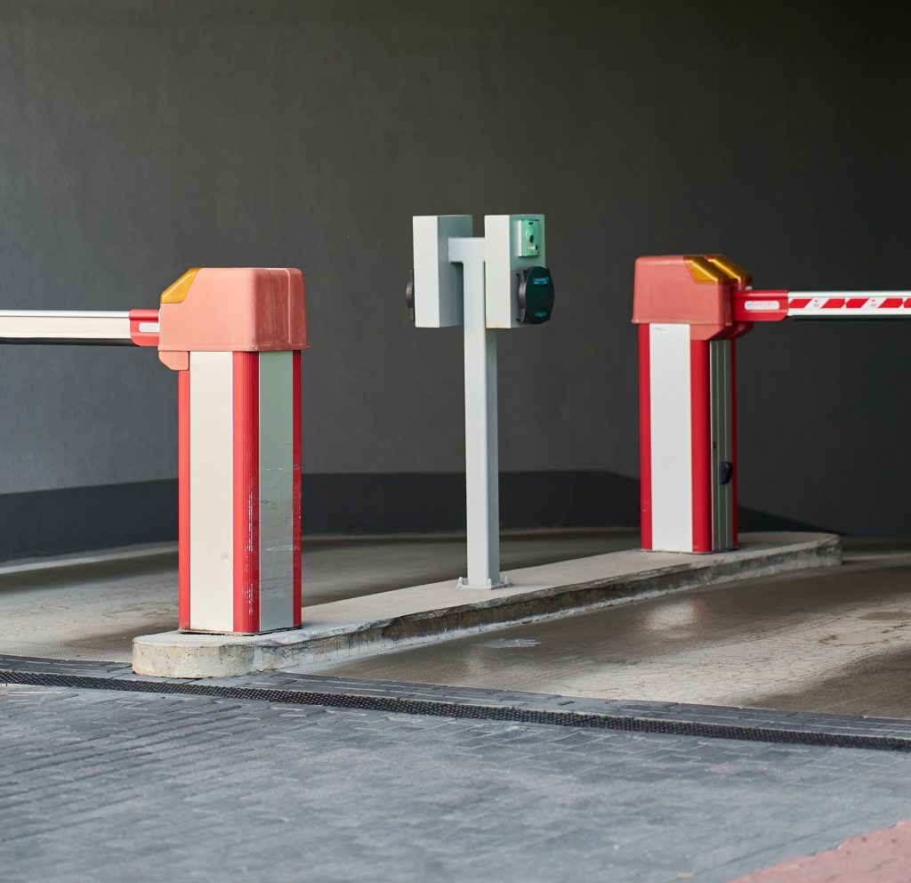 white and red gate arm at modern parking area